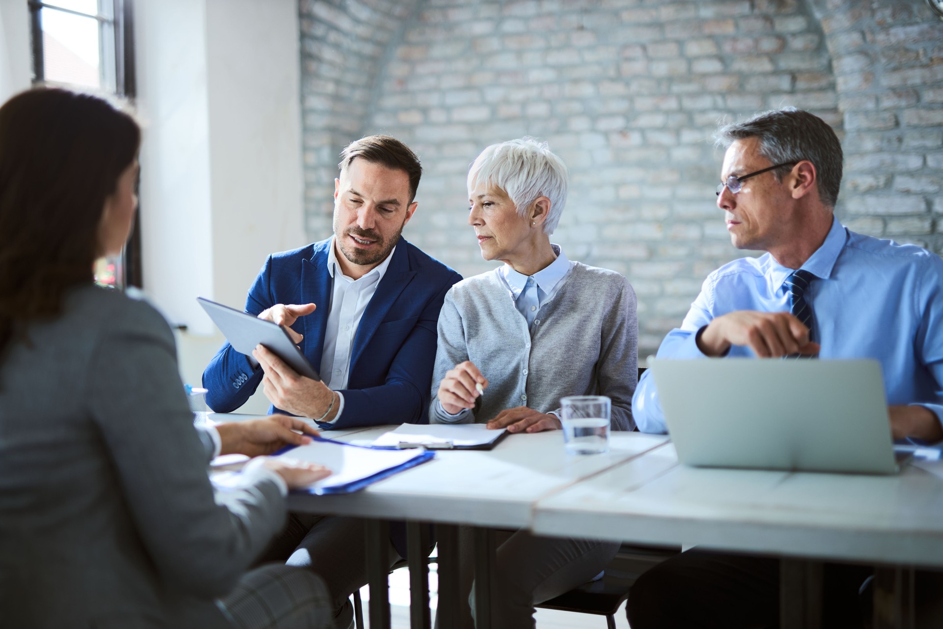 Human resource team using digital tablet on a job interview in the office.